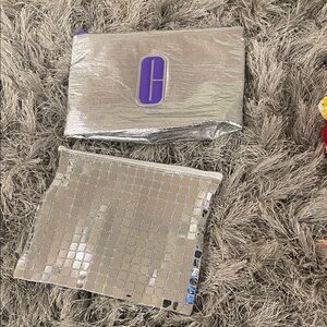 Clinique Metallic Silver Cosmetic Pouches with Purple Logo Accent
